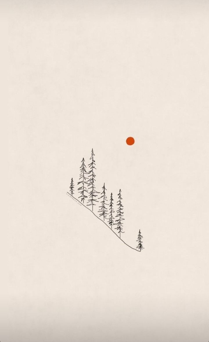 an orange ball is floating in the sky above some trees on a snowy mountain side