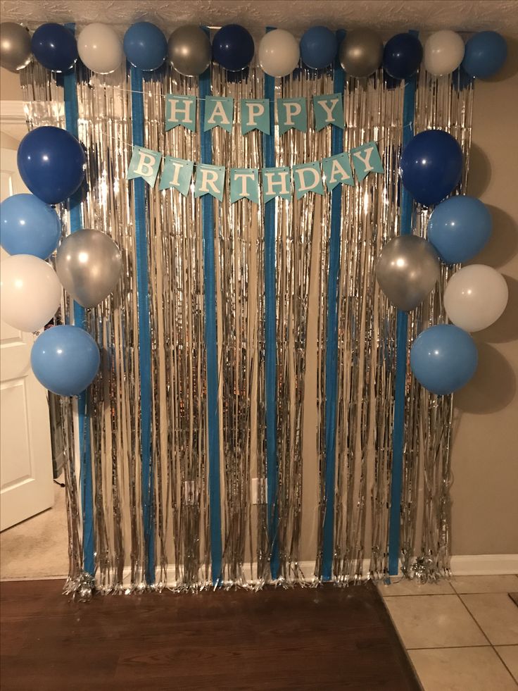 a birthday decoration with balloons and streamers