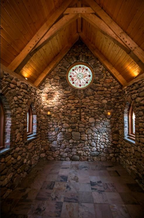 a room with stone walls and two windows