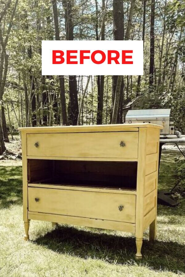 an old dresser with the words before painted on it in front of trees and grass