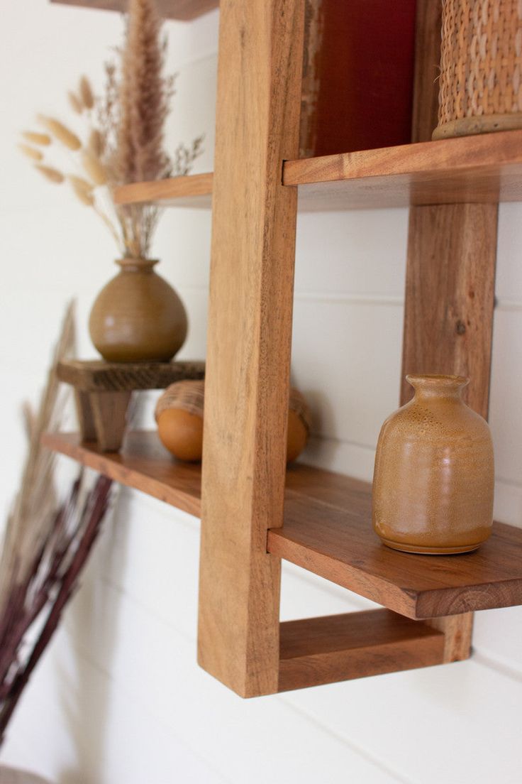 wooden shelves with vases and other items on them