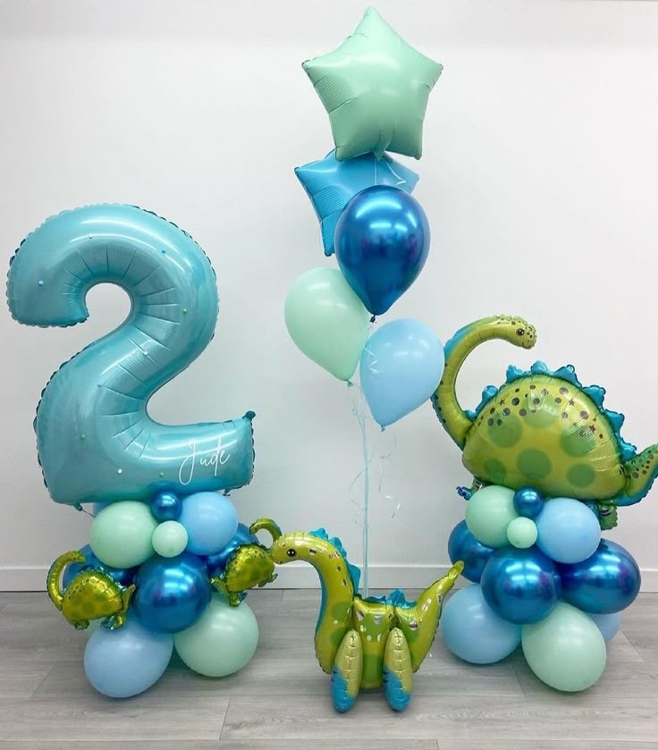 some balloons are in the shape of numbers and dinosaurs