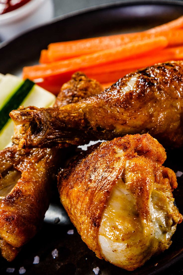 chicken wings with carrots, cucumbers and celery on a plate