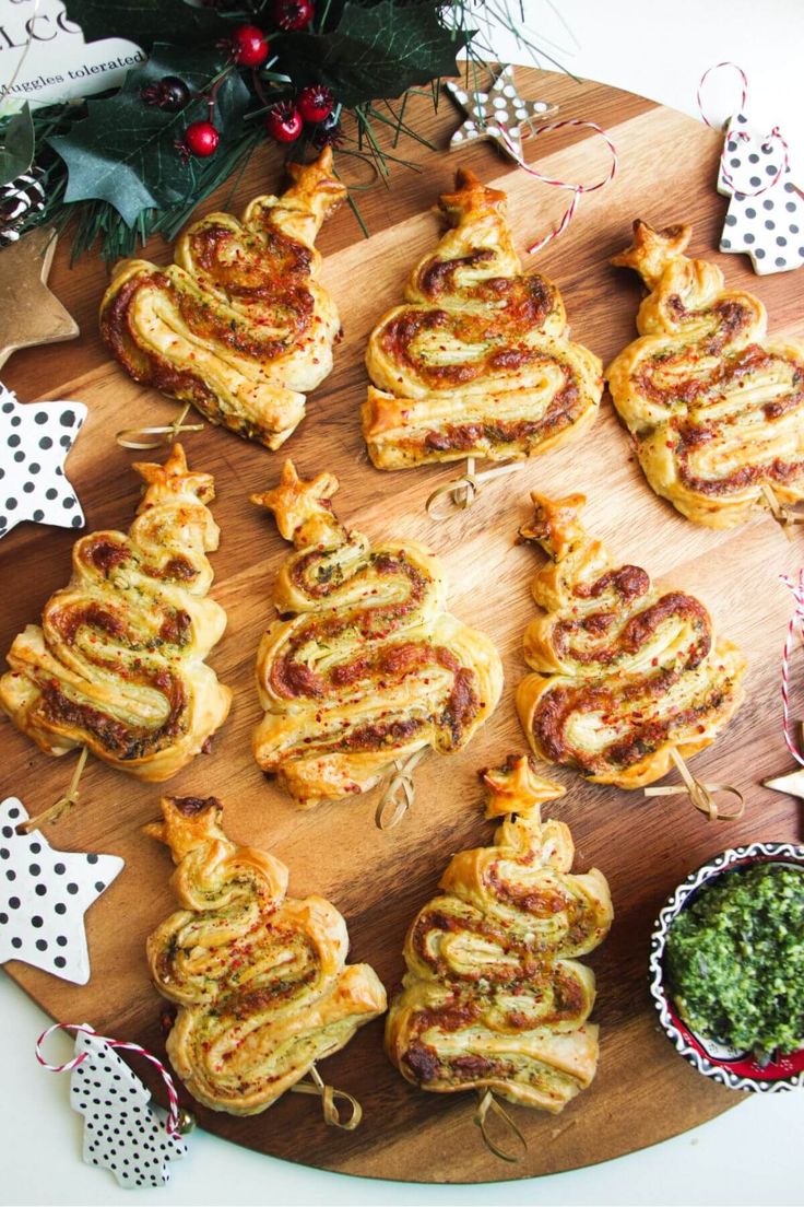 christmas pastries are arranged on a wooden platter