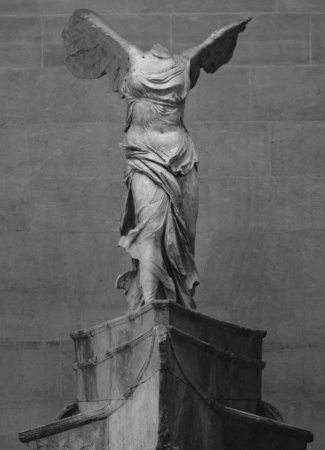 an angel statue is shown in black and white