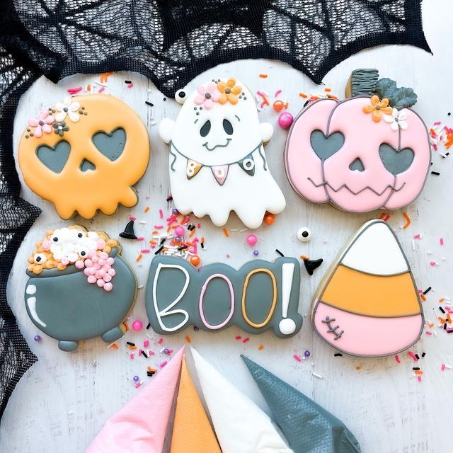 decorated cookies are arranged in the shape of halloween decorations