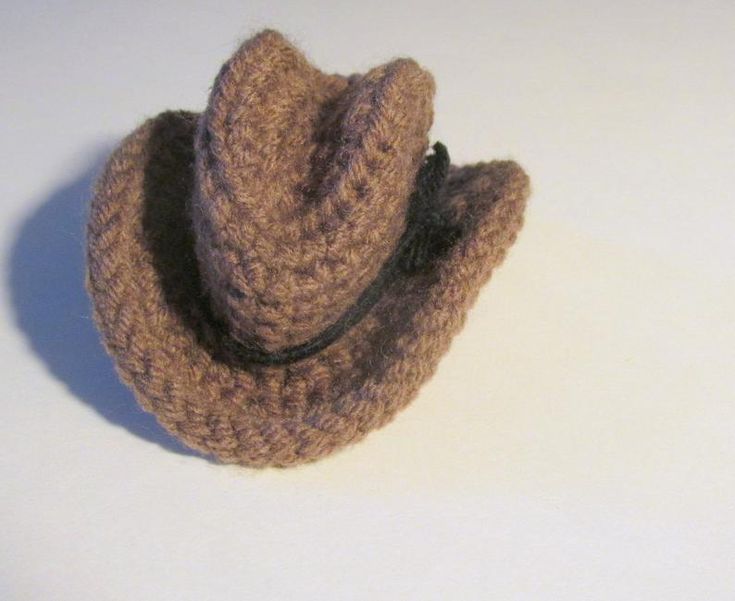 a brown hat sitting on top of a white table