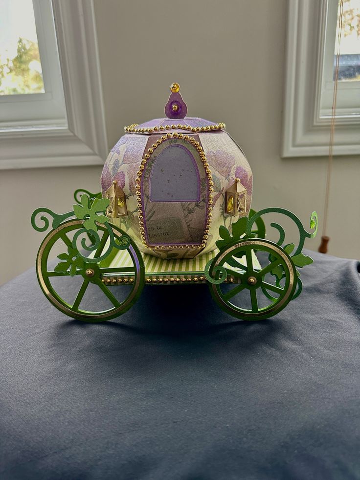 an ornately decorated carriage sits on a table