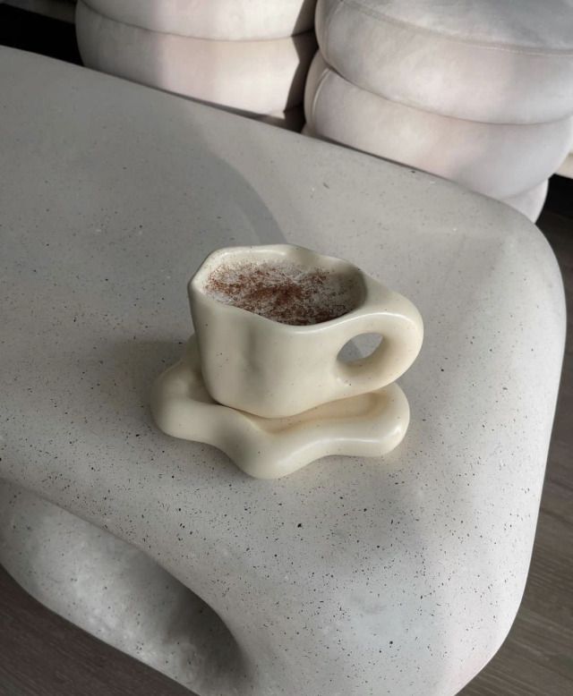 there is a small cup on the table