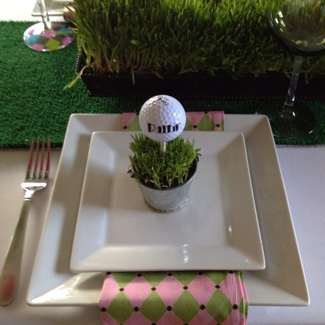 a white plate topped with a plant and a golf ball