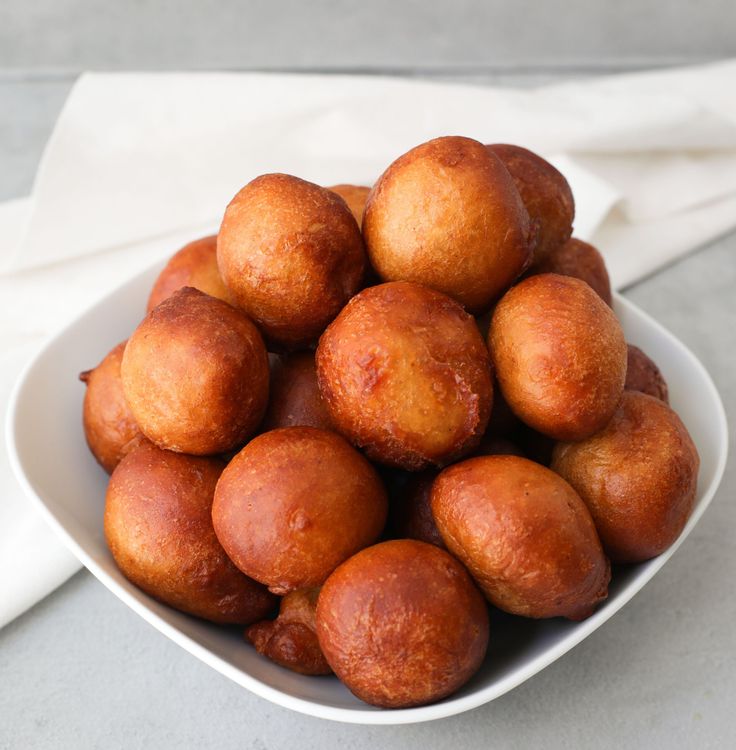 a white bowl filled with fried food on top of a table