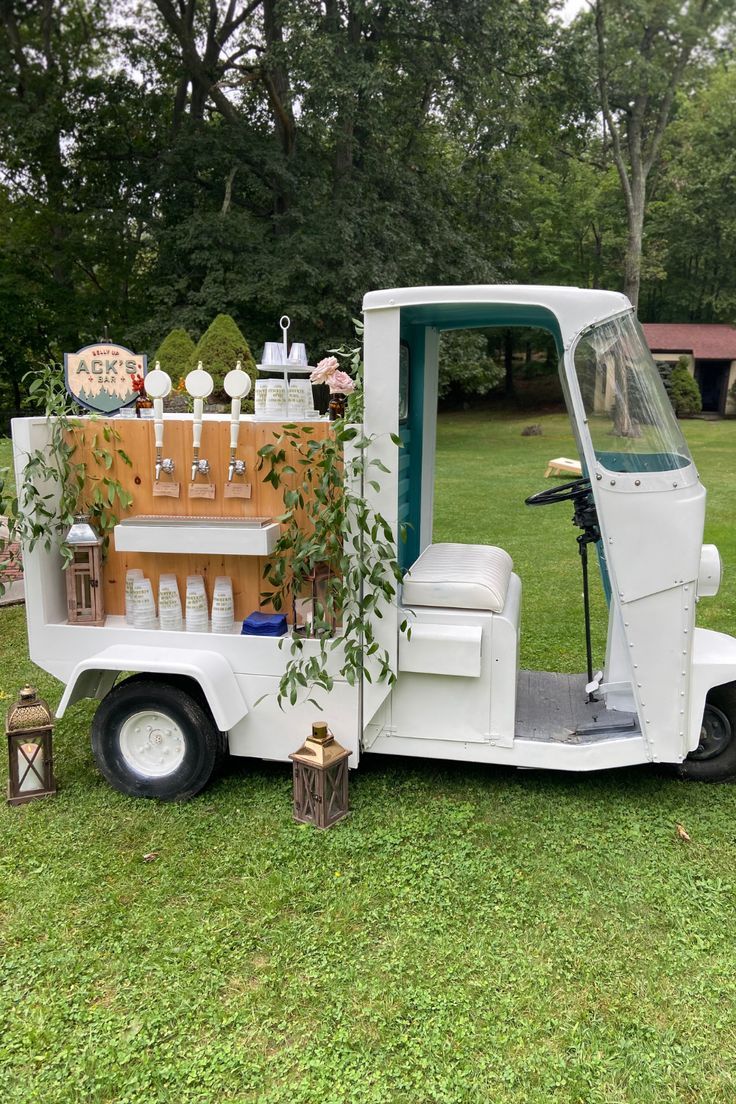 a white truck parked on top of a lush green field