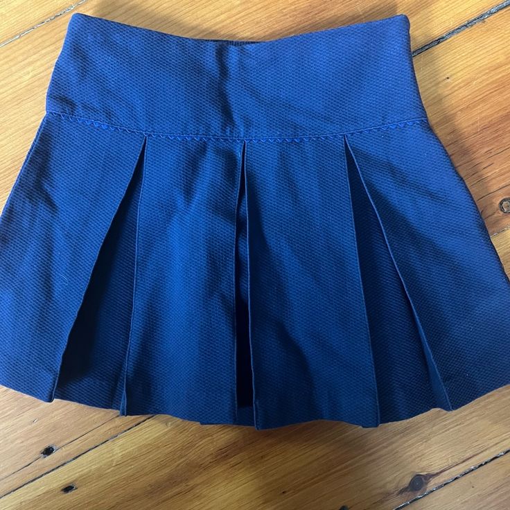 Dark Navy Pleated Skort With Sweet Scalloped Rik Rak Detail. Classic And Trans-Seasonal Because It’s A Perfect Piece To Layer Nwot Navy Casual Tennis Skirt, Cotton School Uniform Skirt, Navy Casual Pleated Skirt Skort, Navy Casual Pleated Skort, Casual Navy Pleated Skort, Preppy School Skirt Bottoms, Navy Pleated Skort Casual Style, Navy Pleated Casual Skort, Blue Cotton Skort For School Uniform