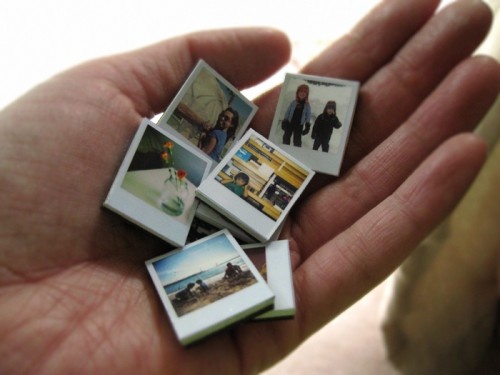 a person holding several small pictures in their palm