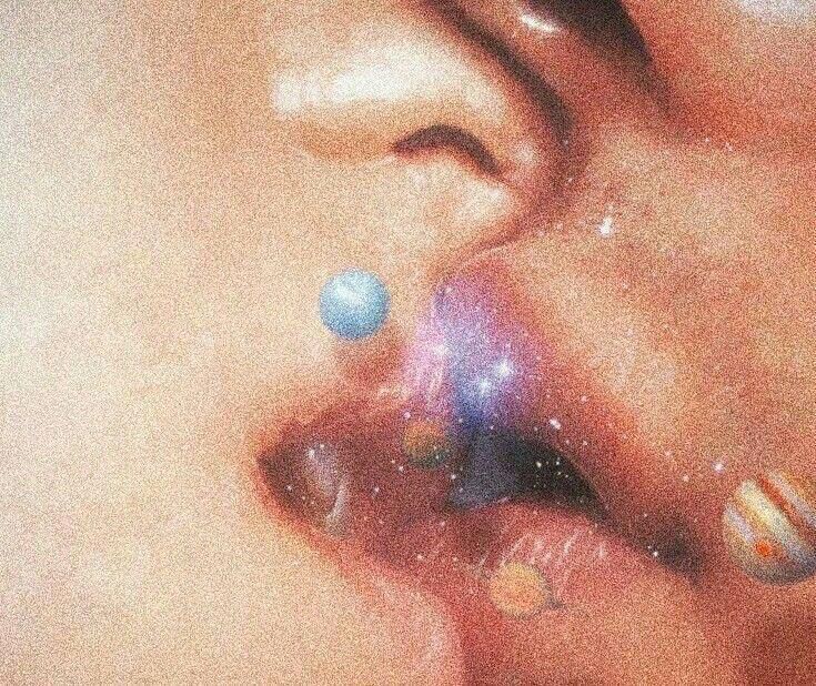 a close up of a person's nose with planets and stars on it,