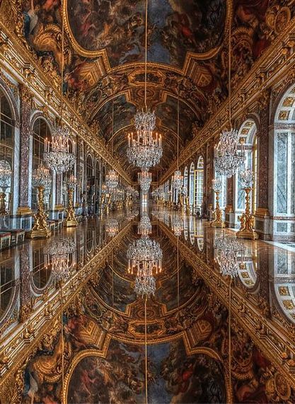 an ornate room with chandeliers and paintings on the walls