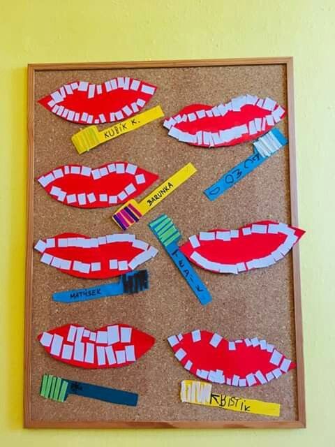 a bulletin board with toothbrushes and strips of paper cut out to look like mouths