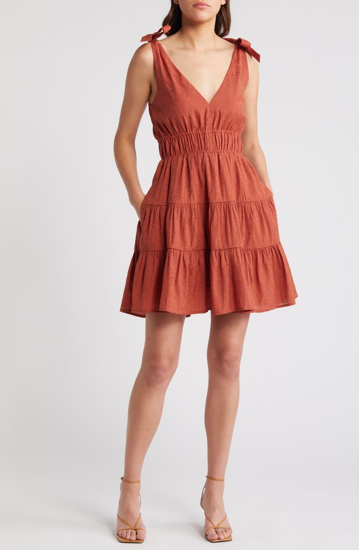 A tiered, ruffled skirt adds playful flounce to this smocked-waist minidress punctuated with ties at each shoulder. 35" length (size Medium) Slips on over head V-neck Side-seam pockets Lined 61% rayon, 27% polyester, 12% nylon Machine wash, line dry Imported Pleated Mini Sundress, Pleated Mini Length Sundress, Casual Tiered Dress With Ruffle Hem, Casual Tiered Ruffle Dress With Ruffle Hem, Casual Tiered Skirt Ruffle Dress With Ruffle Hem, Casual Ruffle Dress With Tiered Skirt, Flirty Mini Dress With Ruffle Hem And Tiered Skirt, Spring Sundress With Ruffles And Mini Hem, Mini Length Tiered Dress With Ruffle Hem