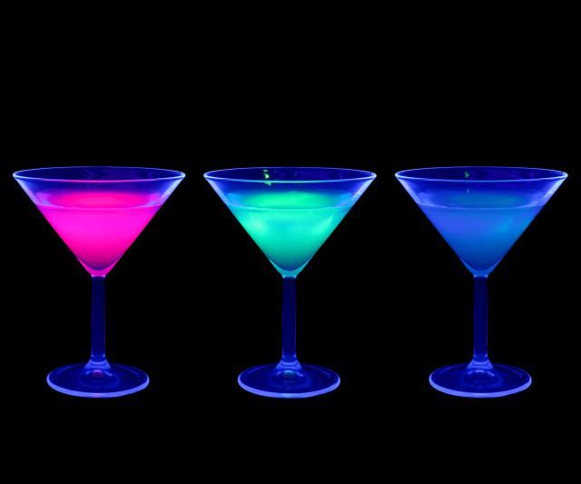 three martini glasses with different colored liquids in the bottom one is blue, the other is pink