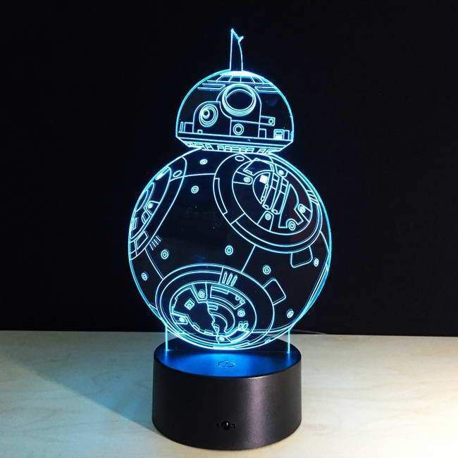 a star wars r2d2 light up lamp on a table with a black background