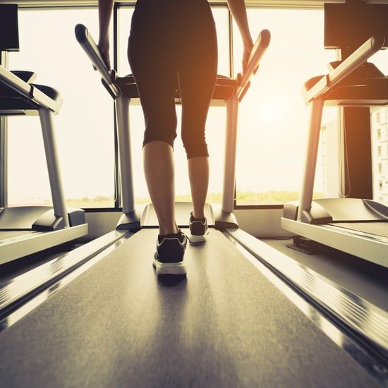 two people are walking down the treadmills in a gym at sunset or sunrise