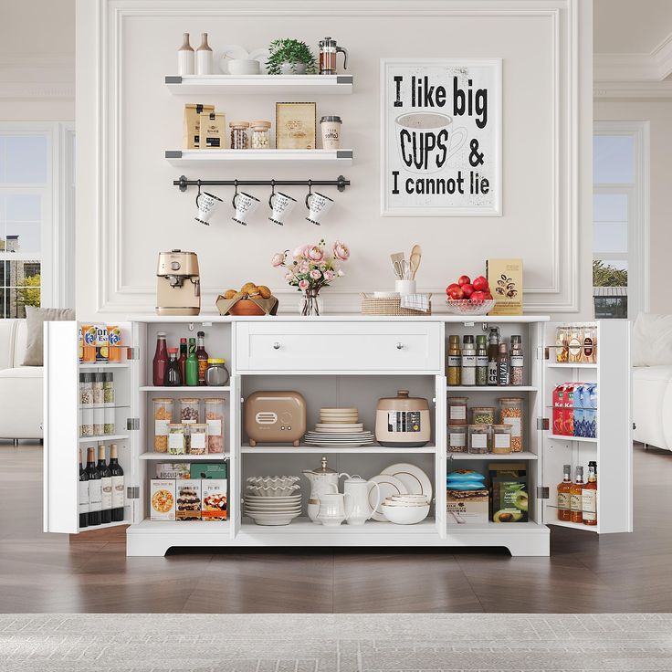 a kitchen with white cabinets and shelves filled with food