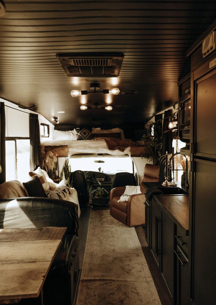 the interior of an rv with couches and tables