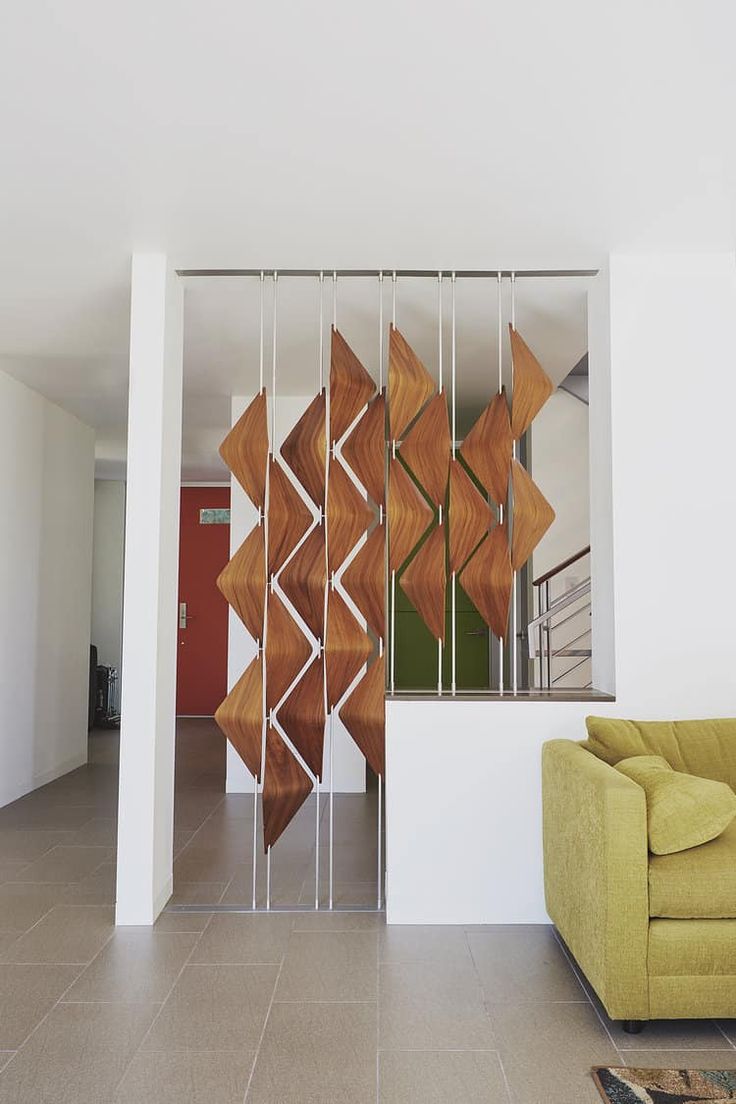 a living room filled with furniture next to a stair case