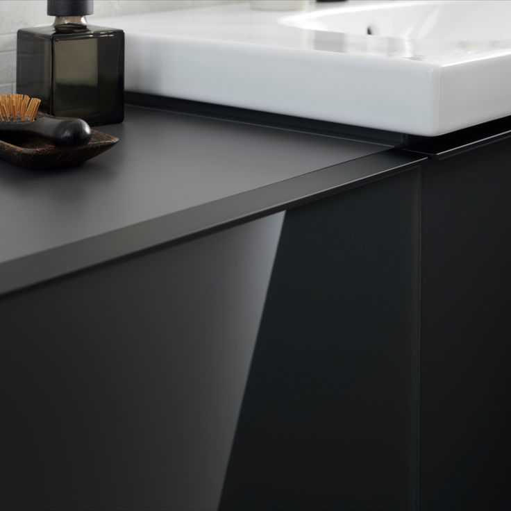 a bathroom counter with a soap dispenser and brush on it next to a sink