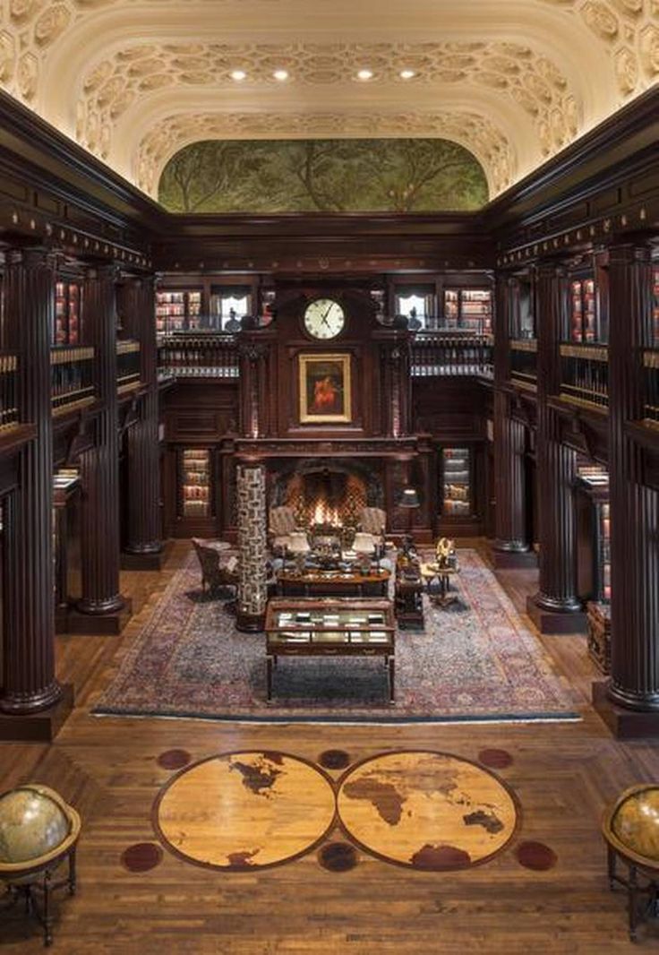 the inside of a library with many bookshelves and couches in it's center