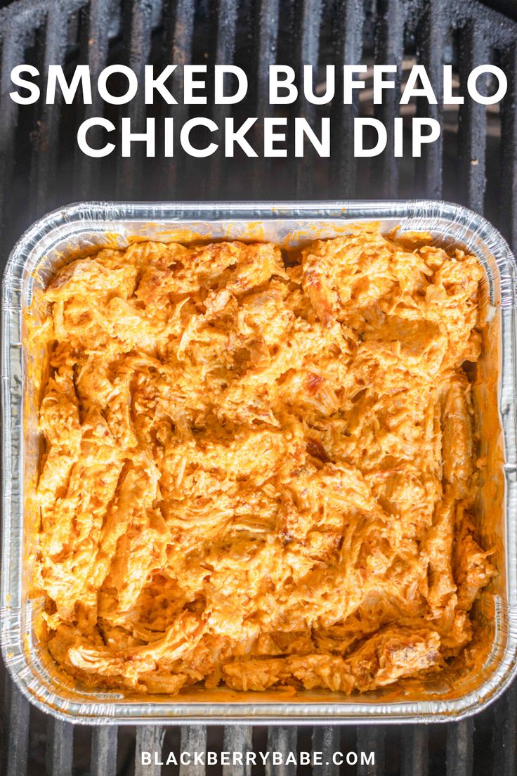 the baked buffalo chicken dip is in a glass dish on top of an outdoor grill