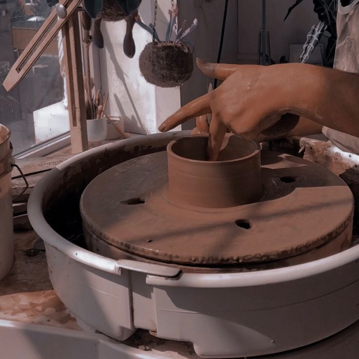 a person is making pottery on a potter's wheel