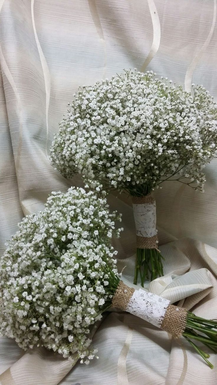 two bouquets of baby's breath on a white cloth