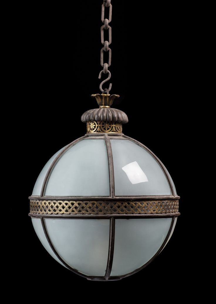 a light hanging from a chain on a black background