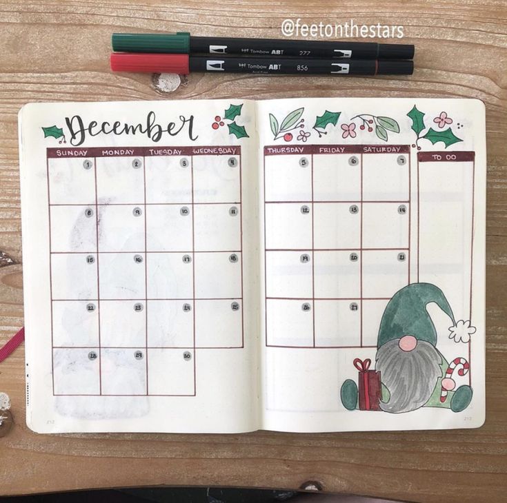 an open planner with christmas decorations on it