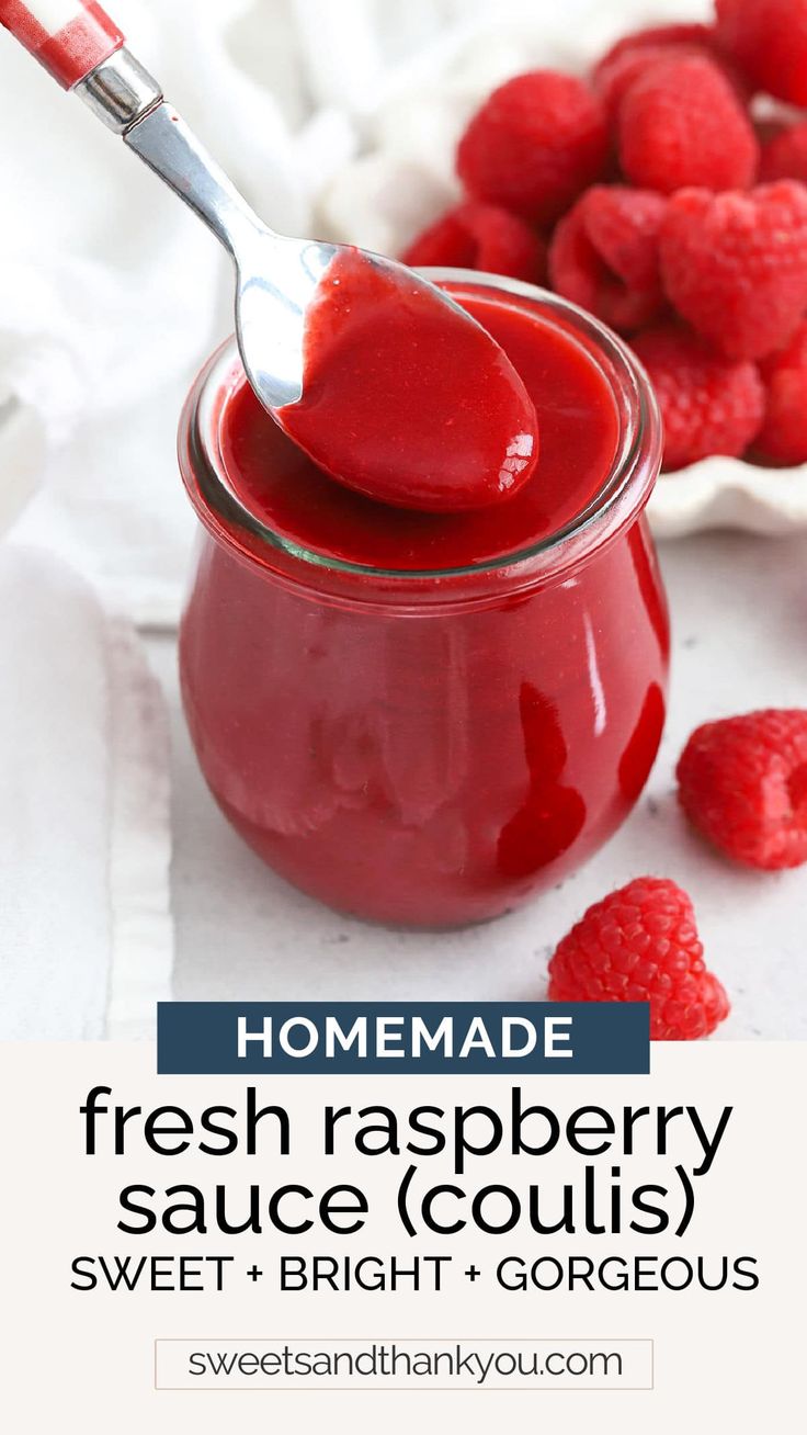 homemade fresh raspberry sauce in a glass jar with a spoon on the side