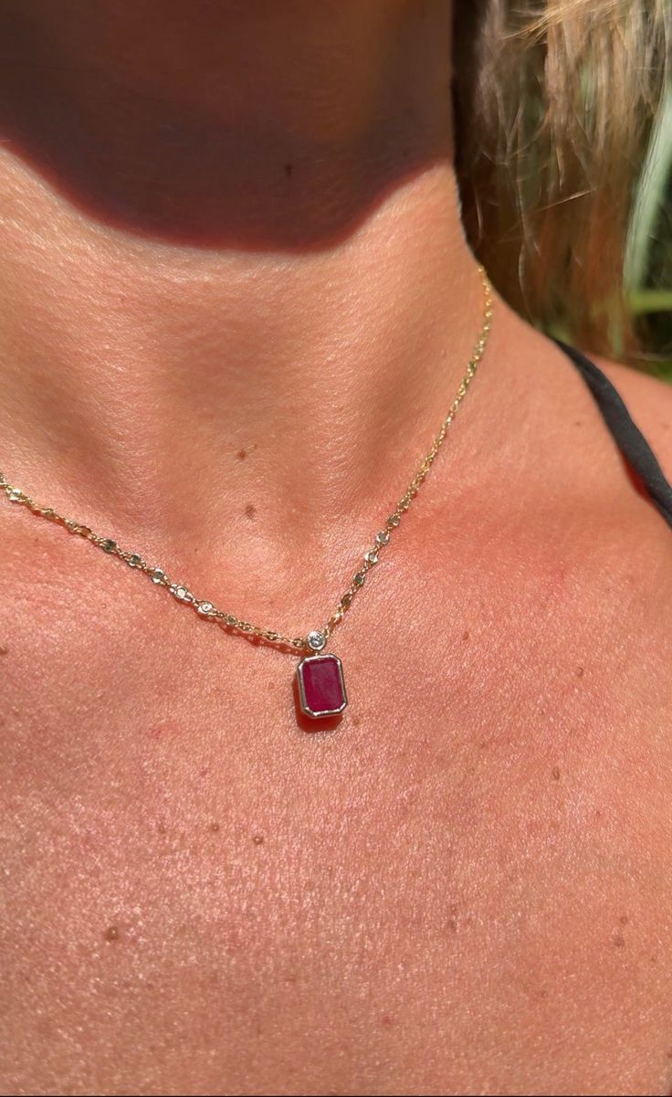 Discover elegance and sophistication with our 14K Yellow Gold Ruby and Diamond Necklace, a stunning piece that exudes timeless beauty. The centerpiece of this necklace is a natural 1.97 carat emerald cut ruby, exquisitely bezel set to showcase its stunning red hue and elegant shape. Complementing the ruby is a sparkling natural round diamond, weighing 0.05 carats, also bezel set for a seamless, refined look. Crafted in lustrous 14K yellow gold, the necklace combines classic design with luxurious Ruby And Gold Necklace, Luxury Ruby Jewelry Radiant Cut, Red Diamond Radiant Cut Jewelry, Red Radiant Cut Diamond Jewelry, Luxury Radiant Cut Ruby Jewelry, Fine Jewelry Ruby With Radiant Cut, Luxury Emerald Cut Ruby Jewelry, Luxury Ruby Jewelry With Rectangular Shape, Luxury Ruby Jewelry In Rectangular Shape