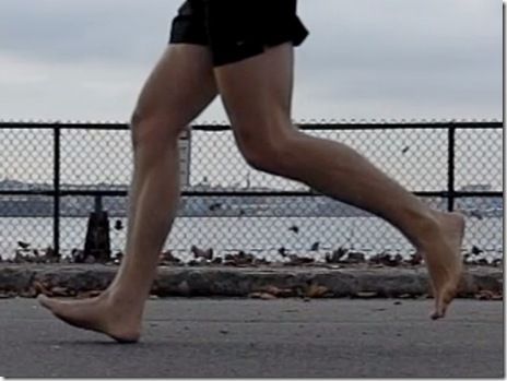 a woman in black shorts is running on the street