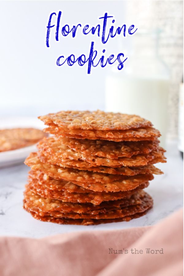 a stack of cookies sitting on top of a table next to a glass of milk