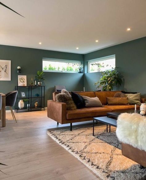 a living room filled with furniture and green walls