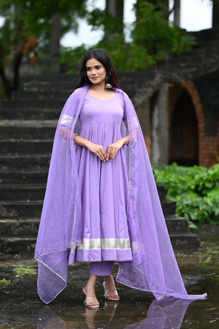 PRODUCT DESCRIPTION :-Shine bright like sunshine!Anarkali :- Pure cottonPant :- CottonDupatta :- Organza silkClosure Used:- Side zipColor:- Lilac purpleCare Instructions :- Dry clean onlyModel Size :- Model is wearing XS sizeModel Height :- 5.5DISCLAIMER :- Slight color variations may occur due to different screen resolution. Purple Anarkali Style Sharara With Cutdana, Purple Churidar With Cutdana For Eid, Traditional Drape Purple Salwar Kameez With Gota Work, Traditional Purple Gota Work Salwar Kameez, Purple Anarkali Set With Straight Kurta For Wedding, Purple Straight Kurta Anarkali Set For Wedding, Purple Churidar With Pallu For Navratri, Purple Bollywood Kurta With Cutdana, Purple Bollywood Style Kurta With Cutdana