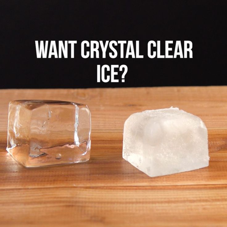 two ice cubes sitting on top of a wooden table