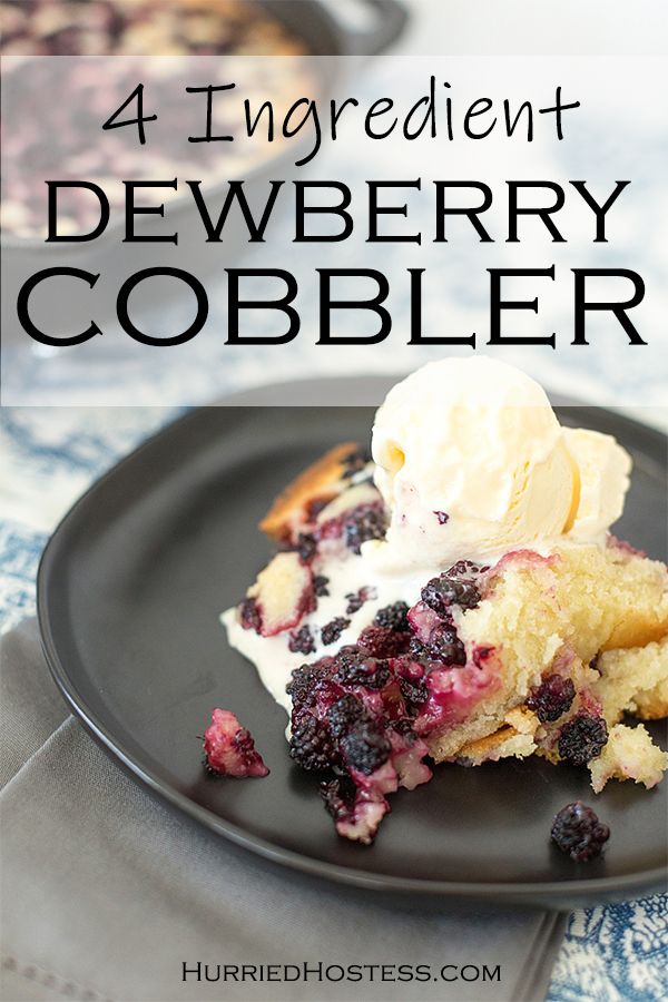 a black plate topped with blueberry cobbler and ice cream