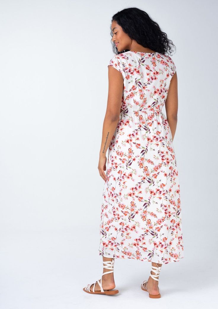 A beautiful bohemian midi dress in a rose pink floral print, with sexy side cutouts. Cotton blend Floral print Relaxed fit Short cap sleeves Mid-length V-neckline Half-elastic waist at the back Self-covered button front Side waist cutouts Women's bohemian spring dress Sexy side-waist cutouts elevate this classic mid-length dress. Designed in a cheerful floral print, with short cap sleeves, a self-covered button front, and a flattering v-neckline. Perfect for spring and summer, we love to pair it V-neck Beach Dress With Rose Print, Summer V-neck Dress With Rose Print, Bohemian Midi Dress With Surplice Neckline And Floral Print, Summer Floral Print V-neck Midi Dress, V-neck Rayon Midi Dress For Garden Party, Spring V-neck Floral Dress With Rose Print, Spring Floral V-neck Dress With Rose Print, Pink V-neck Maxi Dress With Rose Print, Beach Floral Print Midi Dress With Surplice Neckline