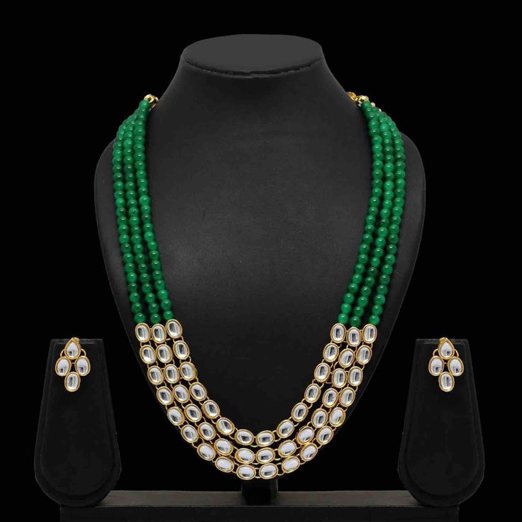 Enhance your outfits with our dignified Ruhi kundan necklace set made with kundan, green beads, and gold plating. This necklace and earrings jewelry set has sophisticated appeal that's perfect for all occasions. Specifications Materials used: kundan, green beads, gold plating Length: 46 cm (necklace), 2.5 cm (earrings) Weight: 120 grams Sold Out! At Romikas, we pride ourselves on the craftsmanship and high quality of our jewelry, designed to enhance your natural beauty. Please contact us with an Green Kundan Beads For Gift, Green Kundan Beaded Necklace Gift, Green Temple Jewelry Mala For Festive Occasions, Festive Green Mala For Celebrations, Green Kundan Necklace With Round Beads, Green Kundan Necklace With Cutdana For Diwali, Green Kundan Cutdana Necklace For Diwali, Green Bollywood Necklace With Round Beads, Festive Green Kundan Necklace For Celebration