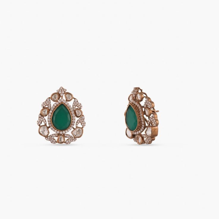 Description : This pair of silver earrings is enlivened by the floral touches, featuring moissanite stones, emerald green stones, and gold-plated silver. This timeless stud brings elegance to your festive event. Product Information : Materials used: 925 Silver with Victorian Plating Stones: Semi-precious stones Length: 3cm Findings: Push back Formal Green Diamond Gemstone Earrings, Formal Green Gemstone Diamond Earrings, Green Hand-set Diamond Earrings, Green Hand Set Diamond Earrings, Elegant Bridal Earrings With Stone Setting, Green Diamond Drop Bridal Earrings, Green Diamond Earrings For Parties, Green Diamond Drop Earrings For Bridal, Green Diamond Party Earrings