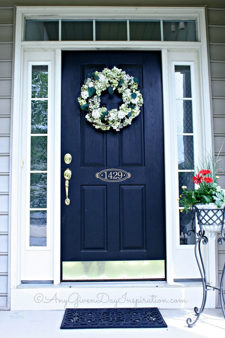 a blue front door with a wreath on it