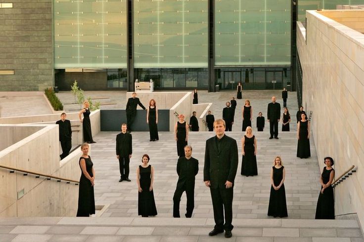 a group of people dressed in black standing on steps