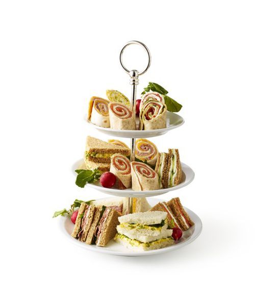 three tiered trays with sandwiches on them