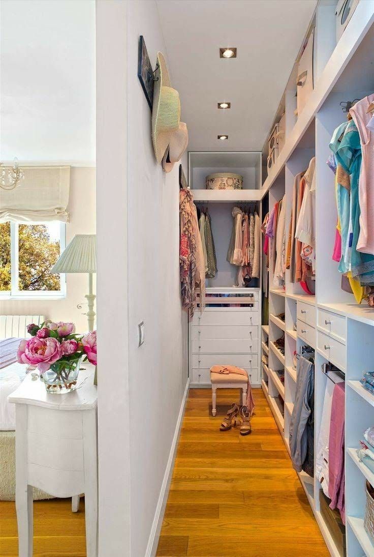 a walk - in closet is shown with clothes on shelves